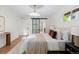 Bedroom with hardwood floors, natural colors, large windows and barn door to bathroom at 7036 S Apache St, Littleton, CO 80120
