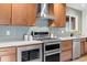 Contemporary kitchen appliances featuring stainless steel oven, microwave, and stylish wooden cabinets at 7036 S Apache St, Littleton, CO 80120