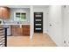 Modern kitchen entrance with stylish cabinets, updated appliances, and beautiful hardwood floors at 7036 S Apache St, Littleton, CO 80120