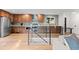 Updated kitchen with stainless steel appliances, wood cabinets, and light countertops at 7036 S Apache St, Littleton, CO 80120