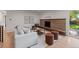 Cozy living room with stone fireplace, plush seating, and lots of natural light at 7036 S Apache St, Littleton, CO 80120