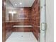 Modern shower with decorative tile, glass surround, built in bench and shelving at 7036 S Apache St, Littleton, CO 80120