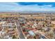 Aerial view showing the property highlighted in a red outline, surrounded by neighborhood homes and roads at 329 2Nd St, Frederick, CO 80530