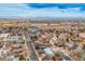 Vibrant aerial view of neighborhood homes and roads under a partly cloudy sky with mountain views at 329 2Nd St, Frederick, CO 80530