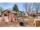 View of the backyard showcasing a garden, shed, and a partially fenced yard at 329 2Nd St, Frederick, CO 80530