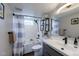 Modern bathroom features a shower with black hardware, a stylish sink, and open shelving at 329 2Nd St, Frederick, CO 80530