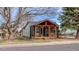 Charming home featuring a covered front porch with wood beam accents and ample outdoor seating at 329 2Nd St, Frederick, CO 80530