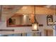 Eclectic home featuring a view to an upstairs area with a hanging lantern, and wooden beams at 329 2Nd St, Frederick, CO 80530