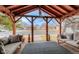 Comfortable covered porch featuring wood ceiling and posts, along with cozy seating at 329 2Nd St, Frederick, CO 80530