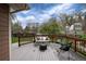 Wooden deck features outdoor seating, wood railing, and lush backyard landscaping at 1970 Garland St, Lakewood, CO 80215