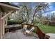 Wooden deck features lounge chairs, wood railing, and lush backyard landscaping at 1970 Garland St, Lakewood, CO 80215
