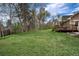 Lush backyard featuring a well-maintained lawn, mature trees, shrubs and a spacious deck, perfect for outdoor living at 1970 Garland St, Lakewood, CO 80215