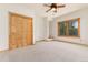Bedroom with carpet, natural wood trim, built-in shelving, and a ceiling fan at 1970 Garland St, Lakewood, CO 80215