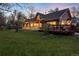 A charming home with a covered porch and a backyard deck surrounded by lush green grass at 1970 Garland St, Lakewood, CO 80215