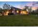 Charming home with a beautiful lawn, covered porch, and warm lighting at 1970 Garland St, Lakewood, CO 80215