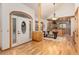 Inviting foyer featuring hardwood floors, a decorative front door, and an open view to the dining and kitchen area at 1970 Garland St, Lakewood, CO 80215