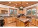 Kitchen with wood cabinetry, granite countertops, kitchen island, hardwood flooring, and recessed lighting at 1970 Garland St, Lakewood, CO 80215