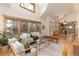 Open-concept living room with high ceilings, hardwood floors, and access to other rooms at 1970 Garland St, Lakewood, CO 80215