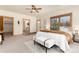 Serene main bedroom featuring large windows, plush carpeting, and ensuite bathroom access; perfect for relaxation at 1970 Garland St, Lakewood, CO 80215