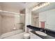 Clean bathroom with a bathtub, sink, and dark vanity at 111 S Monroe St # B207, Denver, CO 80209