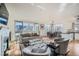 Sunlit living room with hardwood floors, fireplace and access to balcony at 111 S Monroe St # B207, Denver, CO 80209