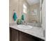 Stylish half-bath with dark vanity, granite countertop, decorative mirror, and modern fixtures at 239 N Irvington St, Aurora, CO 80018