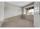 Neutral bedroom with carpet flooring, a window, and a white door at 239 N Irvington St, Aurora, CO 80018