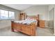 Comfortable bedroom featuring a wood bed frame, matching nightstand and window at 239 N Irvington St, Aurora, CO 80018