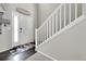 Welcoming entryway featuring dark floors, light walls, and staircase with white banister at 239 N Irvington St, Aurora, CO 80018