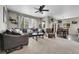 Open concept living and dining area with plush carpet, a large sofa, and adjacent dining set at 239 N Irvington St, Aurora, CO 80018