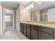 Bathroom featuring double sinks, granite countertop, and tile flooring at 21893 E Layton Dr, Aurora, CO 80015