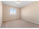 Bedroom featuring neutral carpet, bright lighting, and a window at 21893 E Layton Dr, Aurora, CO 80015