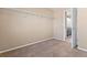 Bedroom with neutral carpet, closet shelving, and an en-suite bathroom at 21893 E Layton Dr, Aurora, CO 80015
