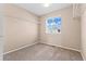 Cozy bedroom featuring neutral carpet, closet shelving, and natural light at 21893 E Layton Dr, Aurora, CO 80015