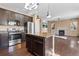 Well-equipped kitchen with granite island overlooks the living room, featuring stainless appliances for modern convenience at 21893 E Layton Dr, Aurora, CO 80015