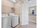 Upstairs laundry area with machines and wire shelving at 21893 E Layton Dr, Aurora, CO 80015