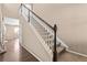 Interior shot of a carpeted staircase with wood trim and white painted spindles at 21893 E Layton Dr, Aurora, CO 80015