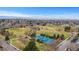 Aerial view of neighborhood park featuring tennis courts, sports fields, and lush green trees at 188 S Locust St, Denver, CO 80224