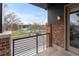 Balcony overlooking a tennis court and treed lawn at 188 S Locust St, Denver, CO 80224