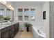 Bathroom features a double sink vanity, soaking tub, and white subway tile at 188 S Locust St, Denver, CO 80224