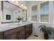 Bright bathroom has a double vanity with a granite countertop and large mirror at 188 S Locust St, Denver, CO 80224