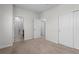 Open bedroom leading into a bathroom with tiled shower and glass door at 188 S Locust St, Denver, CO 80224