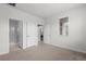 Neutral bedroom with plush carpeting, bright window, and doorways leading to the bathroom and additional room at 188 S Locust St, Denver, CO 80224
