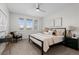 Bright bedroom with a ceiling fan, neutral walls, and two large windows at 188 S Locust St, Denver, CO 80224