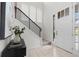 Bright entryway featuring wood-look tile flooring, modern staircase with black railing, and white paneled front door with sidelight at 188 S Locust St, Denver, CO 80224