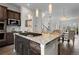 Modern kitchen features a granite island, stainless steel appliances, and dark wood cabinets at 188 S Locust St, Denver, CO 80224