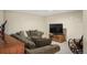 Comfortable finished basement featuring a cozy sofa, television, and a relaxing atmosphere at 7192 S Vine E Cir, Centennial, CO 80122