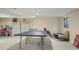 Spacious finished basement area with ping pong table, cabinets, and rec space at 7192 S Vine E Cir, Centennial, CO 80122