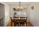 Cozy dining area with hardwood floors and an updated lighting fixture at 7192 S Vine E Cir, Centennial, CO 80122