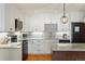 Bright kitchen with white cabinetry, stainless appliances, and granite countertops at 7192 S Vine E Cir, Centennial, CO 80122